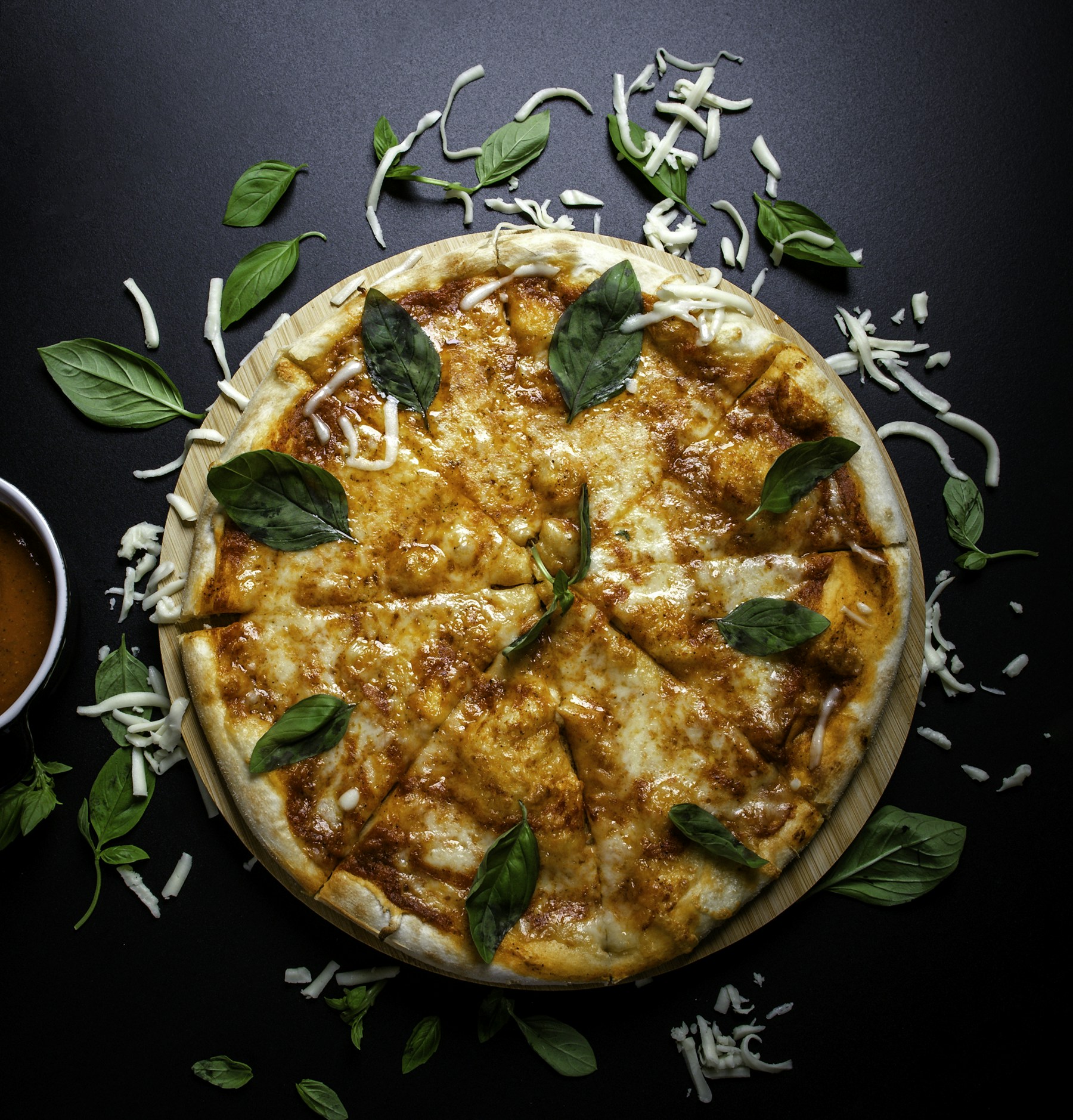 Illustrative pizza with melted cheese and fresh basil